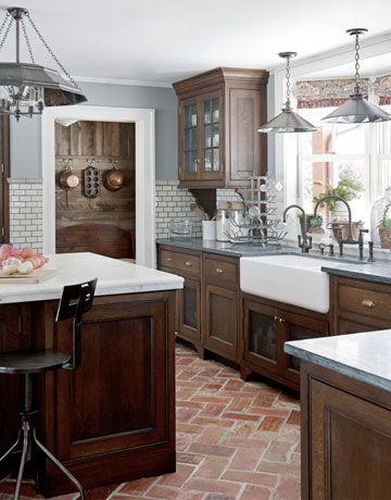 I like the dark cabinets, farmhouse sink, wall tile, & flooring...Kitchen Workspace:   Some of the lower cabinets have a metal grating instead of wood, to add another layer of texture. "It reminds me of those old-fashioned pie safes, and it lets things breathe and dry," Dan Ruhland says. Parefeuille Peach antique terra-cotta flooring from Exquisite Surfaces. Spanish Bathrooms, Copper Counter, Glass Counter, Stone Counter, Grey Counter, Steel Counter, Gray Counter, Rustic Counter, Metal Counter