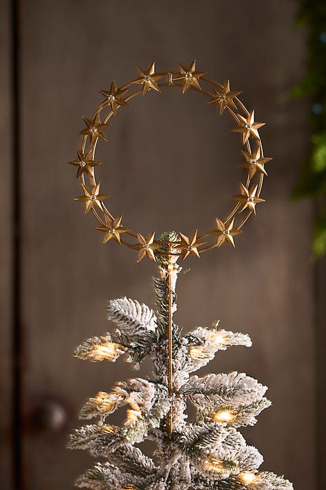 Top off your tree with this gleaming circlet of golden stars. Handmade especially for terrain, each topper can be fastened to your tree with the attached wires or displayed on the matching stand. | Starry Ring Tree Topper in Gold at Terrain Winter Solstice Tree Topper, Cool Tree Toppers, Lighted Christmas Tree Topper, Sparse Christmas Tree Decorating Ideas, Dark Christmas Tree Decorations, Celestial Christmas Tree, Diy Tree Topper Ideas, Witchy Christmas Tree, Yule Tree Topper