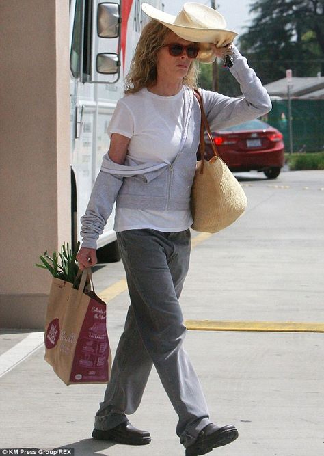 Shady lady: Kim Basinger, 60,  was spotted leaving the Whole Foods Market in Tarzana, California on Friday while holding a large hat above her head to protect herself from the sun Womens Work Tote, Tarzana California, Blonde Actress, Blonde Actresses, Large Hat, Kim Basinger, Shady Lady, Large Hats, Laptop Tote