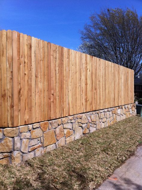 Hillman Outdoor Living wood fence with stone border. Stone And Wood Fence Ideas, Stone Flower Beds, Rock Flower Beds, Backyard Stream, Garden Front Of House, Flower Bed Edging, Outdoor Kitchen Decor, Wood Stone, Backyard Fences