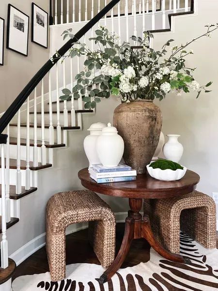 Foyer Table With Stools, Round Foyer Tables, Round Table By Staircase, Entry Way Round Table Decor, Large Round Entry Table, Round Table Hallway, Round Table Foyer Entryway Stairs, Round Console Table Entryway, Styling Round Entry Table