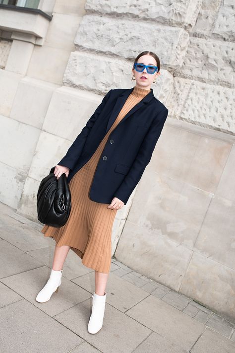 Beige pleated dress under a double breasted navy blue blazer paired with white ankle boots. Navy Blazer With Dress, Beige And Navy Blue Outfit, Dress Under Blazer, Blue Blazer Outfit Women, Navy Blue Blazer Outfits For Women, Beige Ankle Boots Outfit, Navy Blue Blazer Outfit Women, Navy Blazer Outfit Women, Blazer Outfit Women