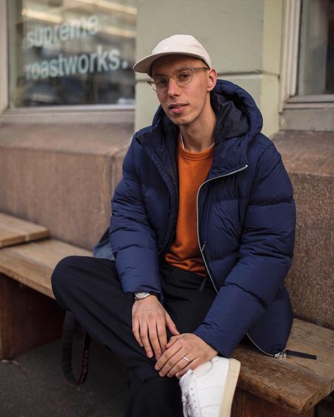 Men’s street style | wearing navy blue down jacket, orange sweatshirt, loose wool trousers and white leather sneakers #mensfashion #streetstyle Orange Outfits Men, Orange Sweatshirt, Minimalist Street Style, Orange Sweater, Navy Outfit, Orange Outfit, Creative Content, White Leather Sneakers, Orange Sweaters