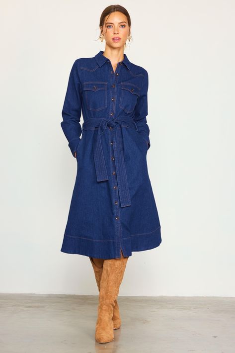 This denim shirt dress comes in a mid-length silhouette with long sleeves and a waist-cinching tie belt. Featuring a clean, dark wash, it showcases Western-inspired flap pockets and yoking accented by contrast topstitching. Button it all the way up to convey a refined look, or leave a few undone to keep things casual. •Pointed collar •Button front placket •Long sleeves with double-button cuffs •Angled yoke •Peaked flap pockets •Optional self-tie belt •Slight Stretch Item Number: 99975 Fabric Con Jean Dress Outfit Fall Boots, Adventure Academia, Denim Dress Outfit Winter, Causal Dress Outfits, Denim Shirt Dress Outfit, Denim Dress Outfit Ideas, Denim Dress Winter, Jeans Dress Outfit, Denim Dress Fall