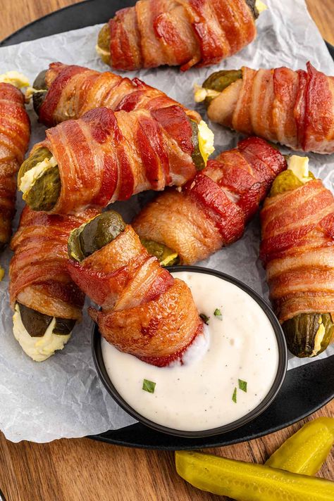 a plate of Bacon Wrapped Pickles with a side of ranch dipping sauce. Pickle Bacon Wraps, Bacon Wrapped Fried Pickles, Dill Pickle Bacon Roll Ups, Ranch Pickles Wrapped In Bacon, Bacon Wrapped Dill Pickle Spears, Stuffed Pickles Wrapped In Bacon, Bacon Wrapped Breadsticks, Jalapeno Bacon Wrapped, Cocktail Wieners Wrapped In Bacon