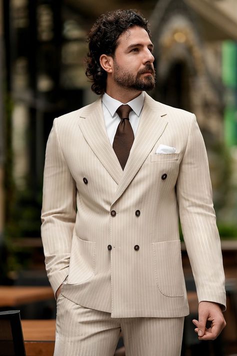 Experience a fresh take on power dressing with this beige striped suit. The structured double-breasted silhouette flatters the form, while the delicate stripe pattern adds a sleek, sophisticated touch to your look.  #beigesuit #stripedtailoring #modernfashion #elegantstyle #tailoredlook #professionalwear #chicensemble #sophisticatedstyle #fashionforward #stylishsuit Beige Double Breasted Suit, Double Breasted Suit Men, Bow Tie Suit, Modern Fit Suit, Suit Stores, Slim Fit Suit Men, Suit Ideas, Beige Suits, Stylish Suit