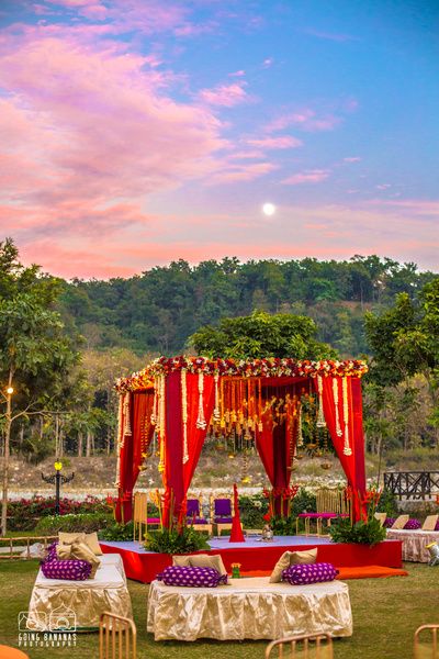 Wedding Decor - Gold and Purple Decor with Red Mandap | WedMeGood | Beautiful Red Mandap Setup in a Open Forest Backdrop #wedmegood #mandap #decor #indianwedding #indiansetup #weddingdecor #indianweddingdecor #decor Indian Wedding Stage, Mandap Design, Wedding Setup, Wedding Hall Decorations, Desi Wedding Decor, Mandap Decor, Marriage Decoration, Beautiful Wedding Decorations, Wedding Backdrop Decorations