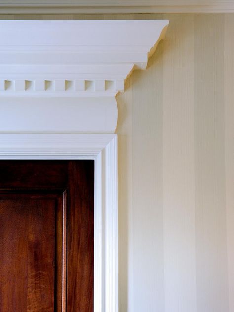 To add a sense of drama, stack dental molding and crown molding several inches above the door frame. By painting the space in-between a matching white, it creates the illusion of the molding being much wider than it actually is––instant gratification! Arched Doorway Trim, Leta Austin Foster, Crown Molding Kitchen, Dental Molding, Humble House, Southern Colonial, Door Frame Molding, Black Interior Doors, Visual Illusion