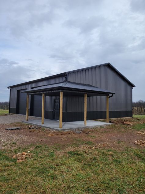 Shop With Garage Doors, Black Wrap Around Porch, Pole Garage Plans, Pole Barn Shop With Porch, Metal Building For Business, Black Morton Building, Tan And Black Metal Shop, Post Frame Garage, All Black Metal Building