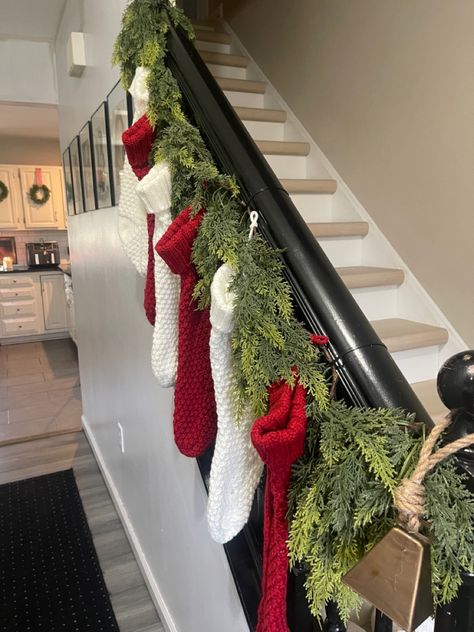 Stocking Hangers No Fireplace Ideas, Christmas Stocking On Stairs, Garland And Stockings On Staircase, Stocking Staircase, Hang Stockings On Stairs, Christmas Staircase Stocking Decor, Ideas For Hanging Stockings, Stockings On Staircase Banisters, Stocking On Staircase