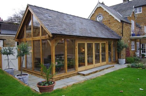 Slate roof fully tiled garden room extension with bifolding doors Rustic Sunroom, Conservatory Sunroom, Oak Framed Extensions, Orangery Extension, Porch Kits, Garden Room Extensions, Screened Porch Designs, Oak Framed Buildings, Sunroom Addition