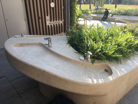 Hand washing sink placed directly outside of the restrooms of the Salisbury Garden's in Hong Kong.  Promoting green design via encouraging interaction between users as well as promoting out doors with Sun and Plants.  Salisbury Gardens, Tsim Sha Tsui, Hong Kong Nature Trail Design, Public Restroom Design, Toilet Plan, Sustainable House Design, Ada Bathroom, Tsim Sha Tsui, Sink In Island, Outdoor Toilet, Restroom Design