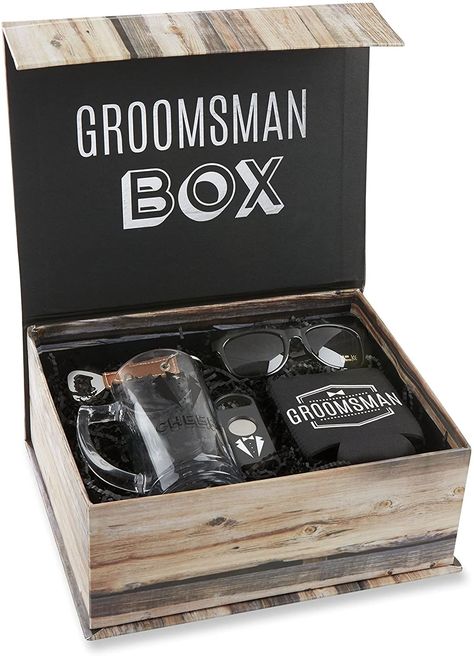 Can’t decide on one specific gift? Give a groomsmen gift box with a few small items or a set of items that go together. One popular groomsmen gift box idea is a nice wooden box with a small bottle of whisky, a nice, possibly engraved glass, and their preferred mixer. Groomsmen Kit, Groomsmen Boxes, Groomsman Proposal Box, Wedding Kit, Groomsmen Gift Box, Be My Groomsman, Wedding Gifts For Groomsmen, Wine Gift Baskets, Groomsmen Proposal