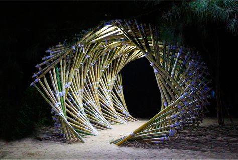 the 20ft cylindrical tunnel is composed of a number of squares that come together to form a spiraling structure depicting a barreling wave. Puri Odisha, Bamboo Building, Bamboo Structure, Bamboo Architecture, Bamboo Decor, Bamboo Construction, Bamboo Art, Bamboo House, Bamboo Garden