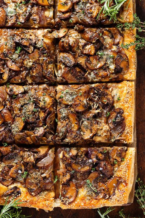 This Puff Pastry Mushroom Tart is made with three kinds of cheeses, caramelized red onions, and garlicky mushroom with rosemary and thyme. This crispy savory mushroom tart makes a great appetizer, lunch, or a light dinner. Serve it as a starter at your next party, Thanksgiving, or Christmas Eve! Mushroom And Onion Tart, Mushroom Puff Pastry Appetizers, Savory Puff Pastry Recipes, Mushroom Tarts, Puff Pastry Recipes Savory, Mushroom Tart, Cheese Puff, Rosemary And Thyme, Onion Tart