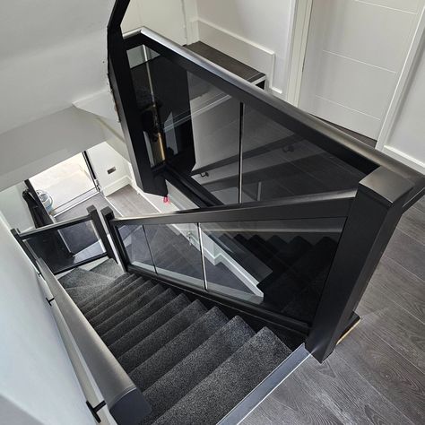 Black staircase balustrade with smoked glass. The black banister is starting to get more and more popular/requested 👌🏼 #staircasebanisters #blackstaircase #glassbanister #blackglassbalustrade Black And Glass Staircase, Black Glass Staircase, Black And Glass Banister, Black Railing With Glass Panels, Glass Banister Landing, Hallway Wall Ideas, Black Banister, Glass Balustrade With Timber Handrail, Glass Staircase Railing