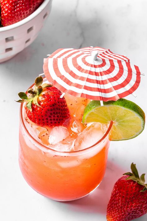 This beautiful, family-friendly drink features zesty lime and ginger beer balanced by sweet strawberries and simple syrup to create an alcohol free mule. Garnish this strawberry mocktail with a lime wheel and cocktail umbrella for a refreshing summer drink. Strawberry Mocktail Recipe, Strawberry Mocktail, Simply Whisked, Cocktail Umbrella, Sweet 16 Party Themes, Lime Drinks, Dairy Free Recipes Dessert, Alcohol Free Drinks, Cocktail Umbrellas