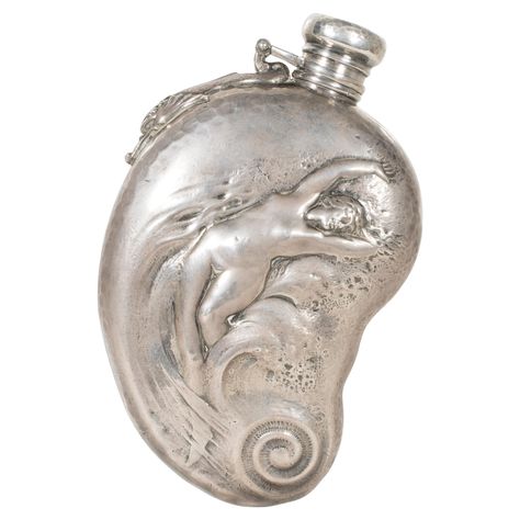 Whiting sterling silver flask. Woman in a wave on front, dolphin near hinge, monogrammed with date on back, and hammered on sides and cap. 6 1/4" PERIOD: Late 19th Century ORIGIN: New York, United States SIZE: 6 1/4", 8.15 troy ounces Whiting Manufacturing Co traces its origin to the firm Tifft & Whiting formed in 1840 by Albert C. Tifft and William Dean Whiting. After the retirement of Tifft the firm changed to Whiting & Gooding (& Co) in 1853, Whiting Fessenden & Cowan (1858), Tifft Whiting & Old Accessories, Attleboro Massachusetts, Silver Flask, Silver Flatware, Cow Boy, Jewelry Inspo, Objects Design, Rhode Island, Sterling Silver Pendant