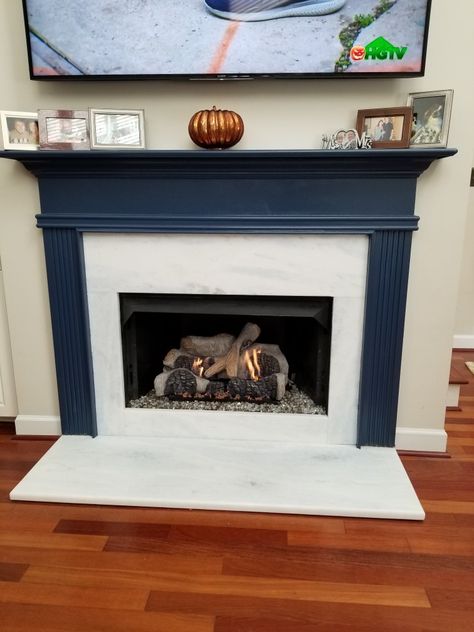 I painted fireplace mantel and place marble with hints of  gray and blue. Replaced logs with Aspen logs....love the new look!@ Navy And White Fireplace, Navy Fireplace Mantel, Blue Gray Fireplace Mantle, Blue Mantle Fireplace, Navy Blue Fireplace Mantel, Painted Blue Fireplace Mantels, Navy Blue Mantle, Dark Blue Fireplace Mantle, Navy Mantle