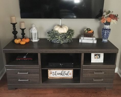 fall tv stand decor Entertainment Stand Decor, Fall Decor Ideas For Tv Stand, Fall Home Decor Tv Stand, Halloween Entertainment Center Decor, Fall Halloween Tv Stand Decor, Entertainment Center Fall Decor, Tv Stand Fall Decor, Tv Stand Fall Decor Ideas, Decor Under Mounted Tv