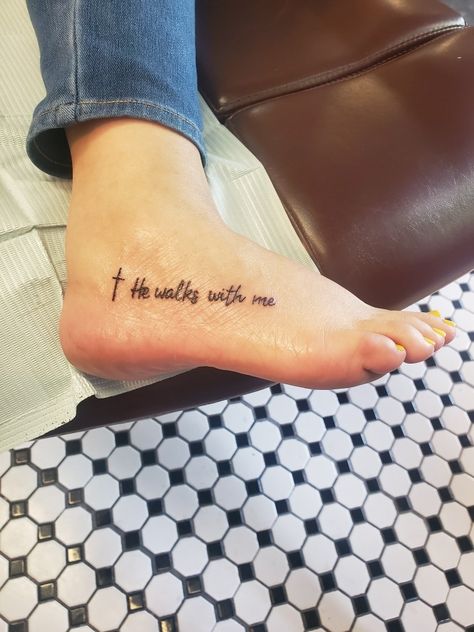 He Walks With Me Tattoo With Cross, And He Walks With Me Tattoo, Walking With God Tattoo, He Walks With Me Foot Tattoo, Dainty Foot Tattoos For Women, He Walks With Me Tattoo, Footprints In The Sand Tattoo, Faith Foot Tattoos, Butterfly Foot Tattoo