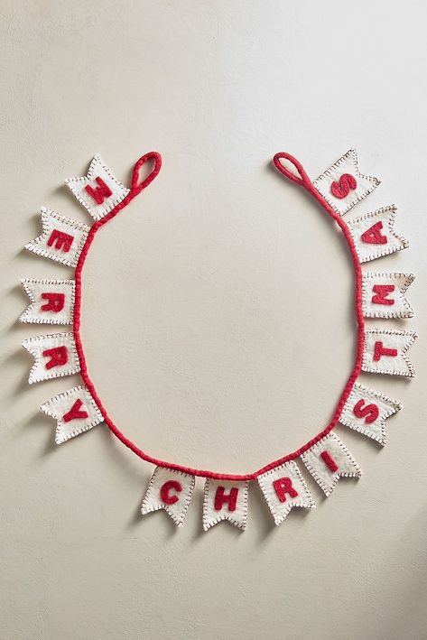 Deck the halls with this festive felted wool garland, which spells out "MERRY CHRISTMAS" in red-and-white pennants. Cardboard Christmas Garland, Bow Garland Christmas, Cricut Garland, Anthropology Christmas, Clay Garland, Felt Garland Christmas, Homemade Garland, Anthropologie Christmas Decor, Christmas Felt Garland