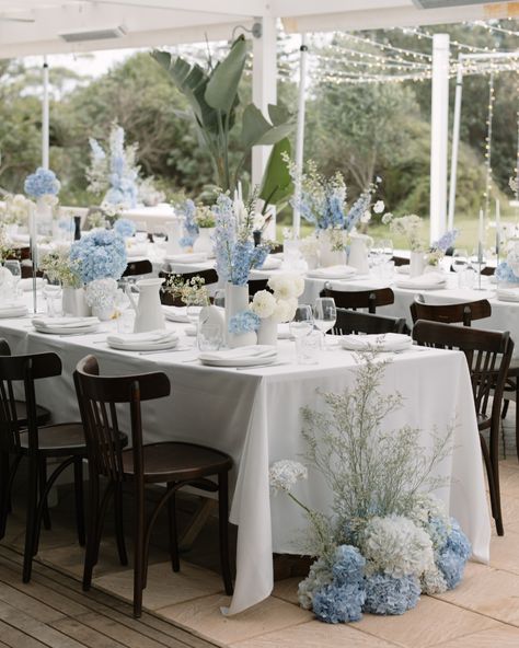 Long Table Centerpieces Wedding Hydrangeas, Wedding Welcome Flowers, Light Blue Tropical Wedding, Delphinium Centerpiece Wedding, Baby Blue Wedding Table Decor, Blue Hydrangea Centerpieces Wedding, Beachy Floral Arrangements, Blue Garden Party Wedding, Light Blue Wedding Table Decor