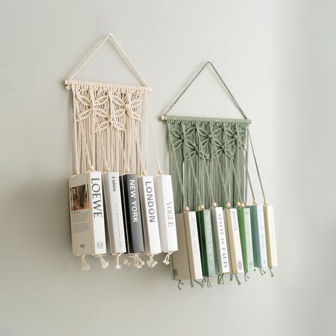 Tis the season to give the gift of reading! Our handmade macrame book holders are the perfect way to show your book-loving friends and family just how much you care. Visit us at https://beandaikon.etsy.com/listing/1716787898 to discover more or reach out to us directly. #BeanDaikon #Macrame #MacrameWallHanger #HandmadeMacrame #HomeDecor #MacrameArt #CraftedWithLove #bookholder #BohemianStyle #HomeStyling #Handcrafted #UniqueDesigns #DecorIdeas #HolidayDecor #UniqueDecor #christmasdecor Macrame Bookshelf, Macrame Book Holder, Wall Hanging Bookshelf, Unique Bookshelf, Mid Century Modern Nursery, Hanging Bookshelves, Unique Bookshelves, Nursery Bookshelf, Cozy Nursery