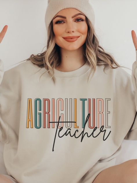 Show your support for the amazing agriculture teachers out there with this stylish Agriculture Teacher Sweatshirt! It's the perfect gift for any AG Teacher, and is sure to be cherished for years to come. It features a trendy design with "Agriculture Teacher" printed on the front. The boho colors will make it stand out, and the soft material will keep you cozy all day. With this Agriculture Teacher sweater, you can show your appreciation for those who help shape the future of agriculture. Ag Teacher Gifts, Agriculture Teacher, Ag Education, Ag Teacher, Teacher Sweater, Boho Colors, Teacher Sweatshirt, Sweater Gift, Colorful Boho