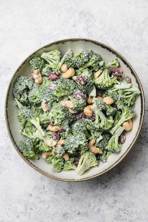 This easy Broccoli Salad recipe is hands down our favorite way to eat broccoli! Toss fresh, raw broccoli florets in a creamy dressing with roasted cashews and dried cranberries. It's crunchy, lightly sweet, and a perfect make ahead side dish for picnics. You'll make this again and again! GF #wellseasonedstudio #broccoli #broccolisalad Brócoli Salad, Raw Broccoli Salad, Easy Broccoli Salad, Picnic Side Dishes, Broccoli Cauliflower Salad, Raw Nuts, Raw Broccoli, Vegan Dressing, Romaine Salad