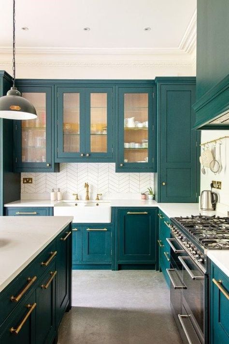 a teal kitchen with glass and usual cabinets, white countertops and a white tile backsplash, gold fixtures and handles Teal Kitchen Cabinets, Cheap Backsplash, Teal Cabinets, Kitchen Decor Trends, Herringbone Kitchen, White Tile Backsplash, Teal Kitchen, Bespoke Kitchen, Dirt Cheap