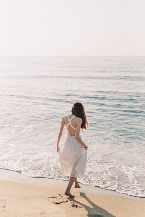 A Woman in White Dress Walking on the Beach · Free Stock Photo White Beach Dress Summer, Best Beach Destinations, White Beach Dress, Beach White Dress, Beach Dress Summer, Beach Destinations, Beach Illustration, Beach Photography Poses, Beach Portraits