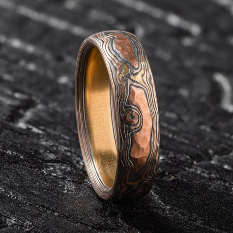 "* Price may vary depending on ring size, please inquire with us directly with your needed size for accurate pricing! This rustic feeling Mokume Gane band is shown in the Woodgrain pattern and the Firestorm metal combination, with a low dome profile, and an etched and oxidized and hammered finish. Firestorm features 14k red gold, 14k yellow gold, Palladium, and sterling silver.   Pattern: Woodgrain Palette: Firestorm  Finish: Etched & Oxidized Profile: Low Dome Width Shown: 5mm Size Shown: 7.25 Add Ons: Hammered Finish Price does NOT include stones or setting fees. We care about customer service and would like to hear from you! Please contact us to help create your treasured item, we take your concerns and requests to heart and will work together to create your unique designs SPECIAL PRICI Mens Jewelry Rings Unique, Unique Engagement Rings For Men, Unique Mens Wedding Bands, Man Wedding Band, Mokume Gane Ring, Woodgrain Pattern, Mokume Gane, Wood Rings, Fantasy Jewelry