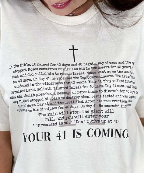 Introducing our "Your 41 Is Coming Graphic Shirt," a meaningful and inspirational addition to your faith-based wardrobe. Available in sizes YXS through 5XL, this natural-colored shirt features the encouraging phrase "Your 41 Is Coming," accompanied by stories from the Bible that highlight the significance of the number 41 and the good things that come with it. Crafted from high-quality, soft materials, this shirt ensures all-day comfort, making it perfect for church services, Bible study groups, spiritual gatherings, or casual wear. The "Your 41 Is Coming Graphic Shirt" serves as a reminder of faith, positivity, and perseverance, drawing inspiration from biblical events where the number 41 marked a time of breakthrough and blessings. Celebrate your faith and encourage others not to give up Encouraging Phrases, Bible Shirts, Faith Based Clothing, Bible Journal Notes, Spiritual Shirts, Christian Post, Bible Study Group, Scripture Reading, Scripture Art