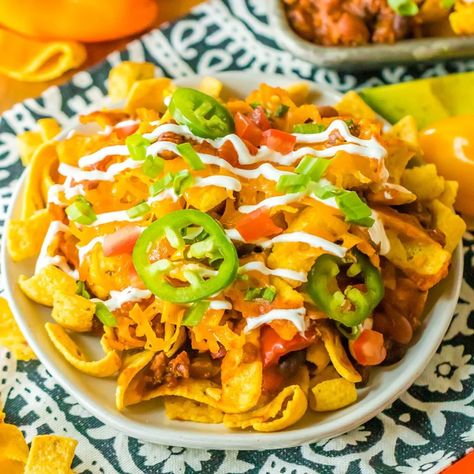 Easy Crock Pot Frito Chili Pie is soul-warming comfort food that is made with slow-cooked beefy chili, crunchy Fritos corn chips, and melted cheese served over more crunchy Fritos. This hearty recipe is so easy to make using simple ingredients, serves a dinner crowd, and is a fan favorite no matter the occasion! | www.persnicketyplates.com Dill Chicken Crockpot, Easy Hot Dog Chili Recipe, Easy Hot Dog Chili, Split Pea Soup Crockpot, Air Fryer Egg Rolls, Hot Dog Chili Recipe, Honduras Recipes, Frito Chili, Frito Chili Pie