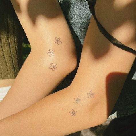 Couple tattoo, tattoo for two, flower tattoo, small tattoo Matching Tattoos For College Friends, Fine Line Flower Tattoo Matching, Matching Tattoos Twins Sisters, Simplistic Best Friend Tattoos, Tattoo For Older Sister, Friends Flower Tattoo, Small Tattoo Ideas Family, Tattoos For Older Sisters, Couple Flower Tattoos