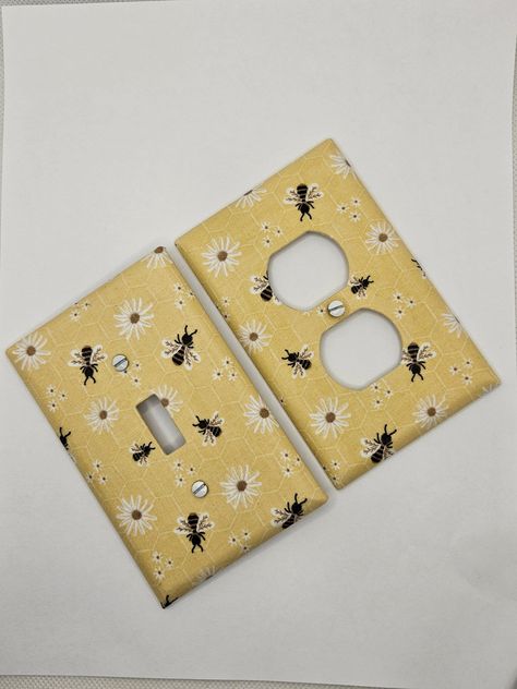 Bumble Bee & Flowers Light Switch and Outlet Covers.  Please view chart in the photos before ordering to ensure you are ordering the correct plate type.  All plates are individually wrapped and come with white head screws. The super cute Bumble Bee Light Switch Covers are the perfect accent to bring a room together.  Perfect for nurseries! These plates are mid-sized, other sizes available upon request.  Orders ship within 3-5 business days. Tracking will be available via USPS.  FREE SHIPPING on Bumble Bee Room Decor, Nursery Bumble Bee, Bug Themed Bedroom, Bee Themed Nursery Baby Rooms, Bee Theme Room, Bumble Bee Kitchen, Bee Themed Nursery, Bee Room Decor, Bee Bathroom