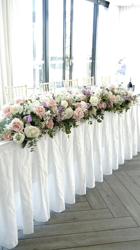 Long Low Flower Arrangement, Long And Low Centerpiece Floral Design, Long And Low Flower Arrangement, Long And Low Table Arrangement, Long Flower Centerpieces Table Garland, Pink Flower Centerpieces Long Table, Wedding Top Table Garland Flower, Bridal Table, Wedding Floral Centerpieces