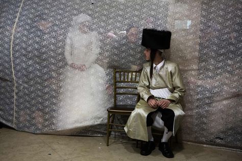 Jewish bride Rivka Hannah (Hofman) looks at her groom Aharon Krois from behind a curtain during the Mitzvah Tans dance ritual following their wedding in an ultra-orthodox neighborhood of Jerusalem on February 18, 2014. During the Mitzvah Tans dance ritual the bride will dance with members of the community, family and with her groom at the end of the wedding ceremony. (Menahem Kahana/AFP/Getty Images) | www.theyearthatwas.in #TheYearThatWas Orthodox Judaism, Wedding Foods, Jewish Wedding Traditions, Jewish Bride, Jewish Weddings, Cruise Fashion, Jewish Culture, Jewish History, Pictures Of The Week