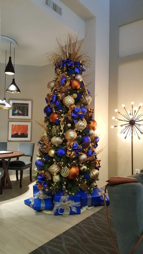 Navy And Orange Christmas Tree, Orange And Blue Christmas Decor, Blue Orange Christmas Tree, Blue And Orange Christmas Tree, Blue And Orange Christmas, Christmas Tree Color Ideas, Blue And Gold Christmas Tree, Orange Christmas Decor, Christmas Tree Color Schemes