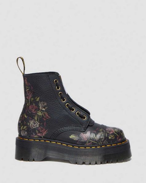 DM’s history with floral designs stretches back decades from prints to DIY-painted Doc’s boots. Our latest incarnation subverts it. The Sinclair boot is a canvas for decaying roses on Tumbled Nappa, an easy-wearing, durable leather with a soft texture. The boot is fitted with a removable jungle zip and highlighted with a rose zip pull. Complementary Indian antique brass trim and hardware elevate the floral design. Unmistakable DM’s attitude is delivered with a smoke Quad sole. Marked as a disrup Fred Perry Amy Winehouse, Dr Martens Sinclair, Edgy Boots, Leather Platform Boots, How To Clean Suede, Brass Trim, Patent Boots, Black Platform Boots, Boots Uk