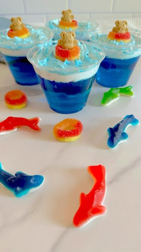 Frosted Little Pandas | 🛟🦈Jello Shark Cups🦈🛟 These yummy shark cups are simple to make and have a fun gummy shark surprise swimming in the Jello. 🦈 To make them… | Instagram Jello Pool Cups, Shark Week Snacks For Adults, Shark Week Desserts, Shark Jello Cups, Shark Week Snacks, Shark Jello, Shark Themed Snacks, Shark Themed Food, Shark Week Recipes