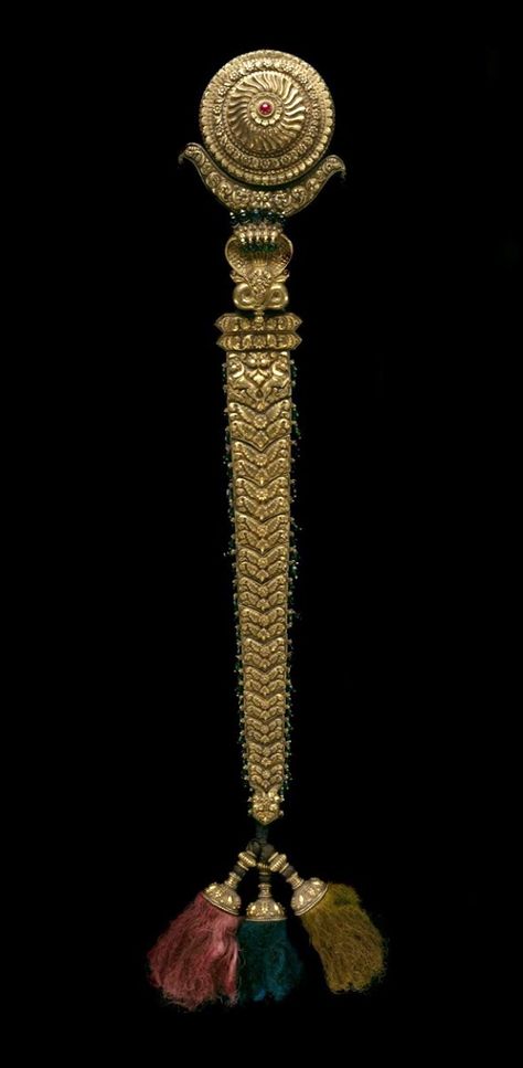 Indian, Hair Ornament, 19th century, Gold, gemstones, and cloth cord. | This superb and elaborate gold hair ornament terminates at one end in tassels and at the other end in many-headed cobras and the figure of Krishna. In Indian mythology, Krishna, the divine hero and eighth reincarnation of the major Hindu deity Vishnu, is said to have defeated the evil multiheaded serpent Kaliya that was poisoning the waters of the Yamuna River. Hair Accessories Indian, Indian Wedding Jewellery, Indian Bangles, Accessories Indian, Trendy Jewerly, Gold Hair Accessories, Heritage Jewellery, Gold Jewellery Design Necklaces, Indian Wedding Jewelry