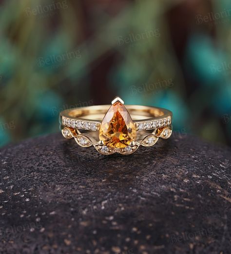 Pear shaped Imperial Topaz Diamond engagement ring set, Vintage yellow gold moissanite/diamond unique ring, art deco anniversary bridal set --------------------Specifications---------------------- Engagement ring Center Stone - 6*8mm Imperial Topaz Side stones - about 0.09ct Moissanite or Diamond Diamond Clarity - SI Diamond Color - H-G Wedding band Stones - about 0.09ct Moissanite or Diamond Diamond Clarity - SI Diamond Color - H-G ---------------------DIMENSIONS---------------------- Engagemen Canary Diamond Engagement Ring, Pave Wedding Band, Citrine Engagement Ring, Citrine Ring Engagement, Pave Wedding Bands, Promise Ring Set, Citrine Jewelry, Yellow Engagement Rings, Topaz Engagement Ring