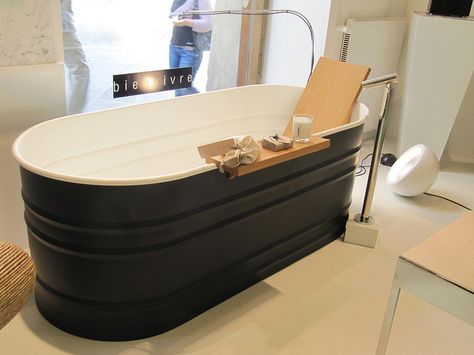 Is this custom fabricated, or is it actually a painted stock tank? Black and white tub, wood backrest and bath shelf. Modern faucet, floor mounted. Water Trough Bathtub, Stock Tank Bathtub, Galvanized Bathtub, Trough Bathtub, Bathtub Inspiration, Diy Stock Tank, Modern Tub, Galvanized Tub, Stock Tank