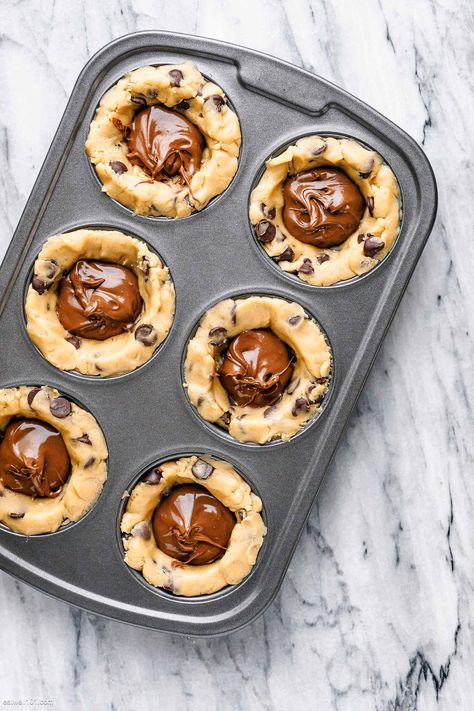 Nutella Stuffed Cookie Cups - #nutella #cookies #recipe #eatwell101 - These fun Nutella cookie cups are baked in a muffin pan and filled with Nutella for the absolute best crunch. - #recipe by #eatwell101® Nutella Stuffed Cookie Dough Cups, Nutella Cookie Cups, Nutella Cookie Cake, Mini Cookie Cups, Stuffed Cookie Recipes, Nutella Cups, 2023 Desserts, Nutella Stuffed Cookies, Nestle Cookies