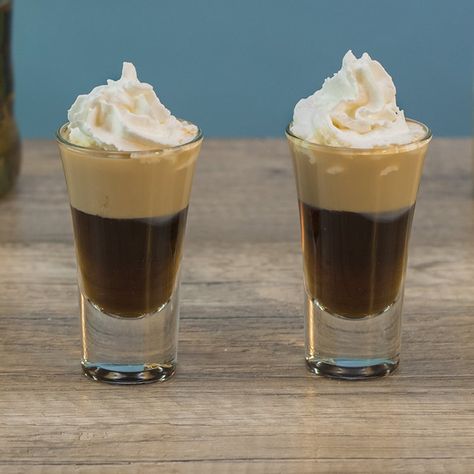 BANANA BREAD SHOOTER 3/4 oz. (22.5ml) Chocolate Liqueur 3/4 oz. (22.5ml) Banana Liqueur 1/2 oz. (15ml) Irish Cream Garnish: Whipped Cream PREPARATION 1. Add ice, chocolate liqueur and banana liqueur to shaking glass and combine well. Pour into shot glass. 2. Use a spoon to gently layer irish cream on top before finishing with whipped cream. DRINK RESPONSIBLY! (User Submitted by Brandon @ TipsyBartender.com) Holiday Shot Recipes, Amaretto Recipes, Tipsy Bartender Recipes, Drinking Shots, Layered Shots, Baileys Cocktails, Bachelorette Party Drinks, Shooter Recipes, Themed Cocktails