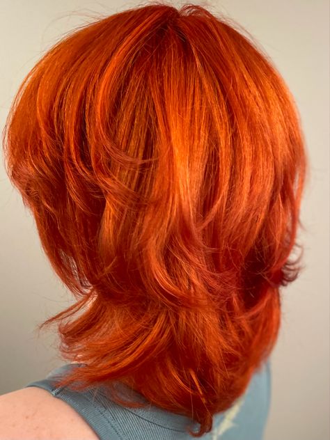 Bright Orange Copper Hair Color on a Medium Length Shaggy Wolf Cut Orange Hair With Layers, Orange And Copper Hair, Orange Hair Shades, Copper Wolf Cut, Ginger Hair Wolf Cut, Dyed Hair Orange, Red Hair Color Wolfcut, Bright Copper Red Hair, Red Orange Hair Color