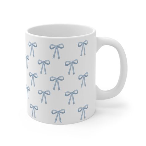 ♡ ୨୧  Coquette Soft Girl Aesthetic Blue Bow Mug  ୨୧ ♡ About : .:  Blue Bow Design  .:  11oz (0.33 l) mugs are made with durable white ceramic  .:  comfortable C-handle .:  Drink confidently on a daily basis as all mugs are lead and BPA-free. .:  Microwave & dishwasher-safe .:  Prefect gift for her  .:  Perfect gift for coffee, tea, and chocolate lovers. .  . . ⋆ Returns :  Our products are made to order, so returns and exchanges are not accepted.  . . . 𓆩♡𓆪 Share the joy of coquette Blue Bow Mug with a friend or loved one. . . . ໒꒰ྀི' ˘ ` ꒱ྀིა Thankyou so much shopping with us, please share your picture and tag us!! :) Please reach out if you have any question!  . Instagram:  @lalala.deer Email: Lalaladeer.boutique@gmail.com Cute Mugs Aesthetic, Mugs Aesthetic, Blue Ribbon Bow, Color Me Mine, Bow Wallpaper, Blue Cups, Soft Girl Aesthetic, Aesthetic Coquette, Cute Cups