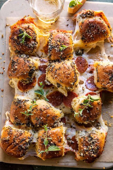 These easy Homemade Pull Apart Roasted Garlic Pizza Dip Sliders are such a fun and easy appetizer for everything from game day to holiday parties. Soft dinner rolls stuffed with marinara sauce, cheese, and pepperoni. Each handheld pizza slider is cheesy on the inside, yet golden toasted outside, with a delicious roasted garlic butter topping. Tieghan Gerard, Pizza Slider, Half Baked Harvest Recipes, Garlic Pizza, Pizza Dip, Most Popular Desserts, Harvest Recipes, Popular Desserts, Half Baked